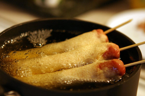 Corn Dog Niman Ranch corn dogs frying.