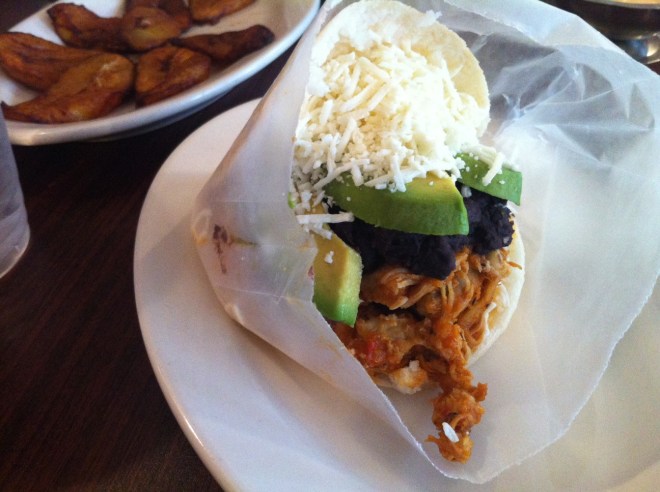 The chicken arepa with sliced avocado, black beans and cheese.