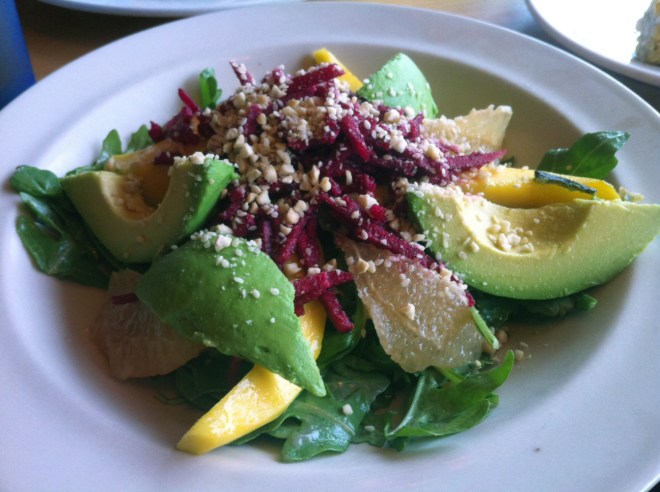Reggie's Raw Heaven salad: ugula – Mango – Grapefruit – Avocado Beet Infused Jicama – Cashew Gamasio – Pomegranate Dressing